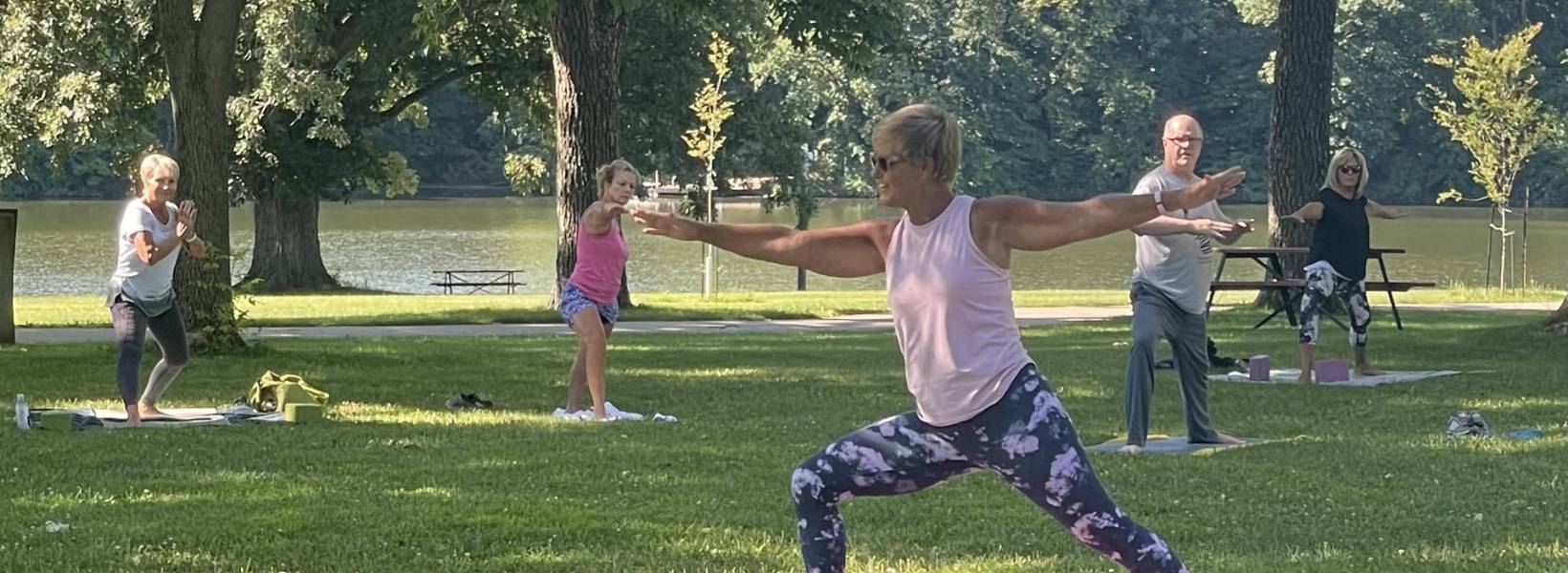 People doing yoga in a park