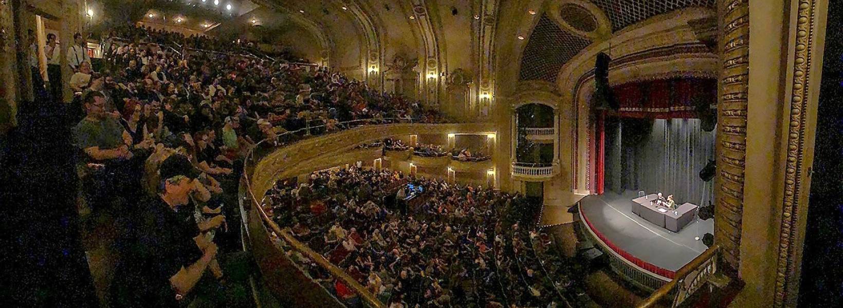Image of a theatre filled with people