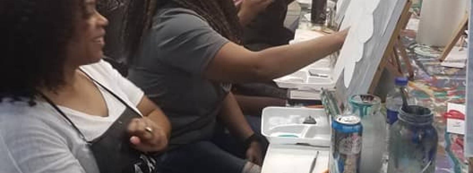 Men and women painting 