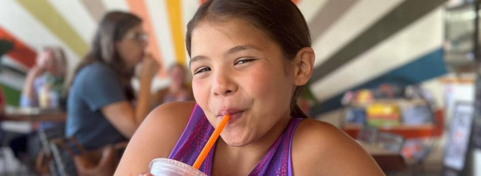 Image of a girl drinking a smoothie through a straw