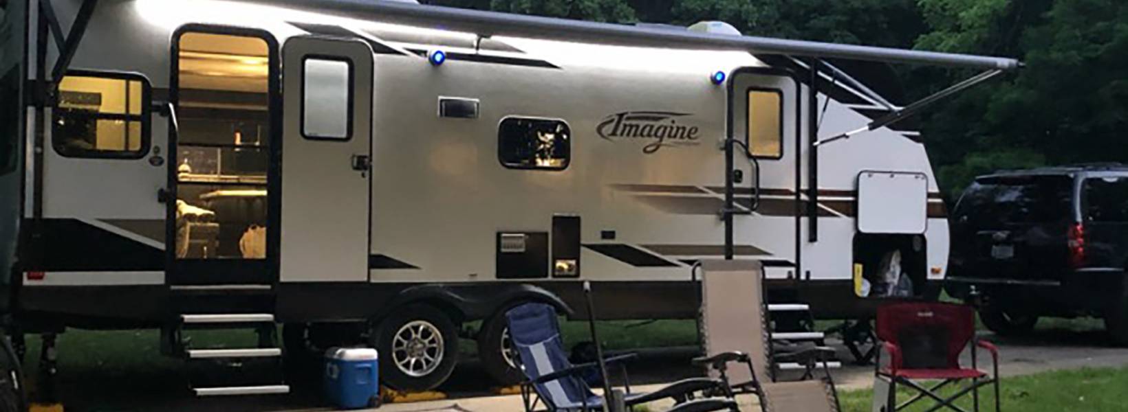 Image of a camper with chairs in front